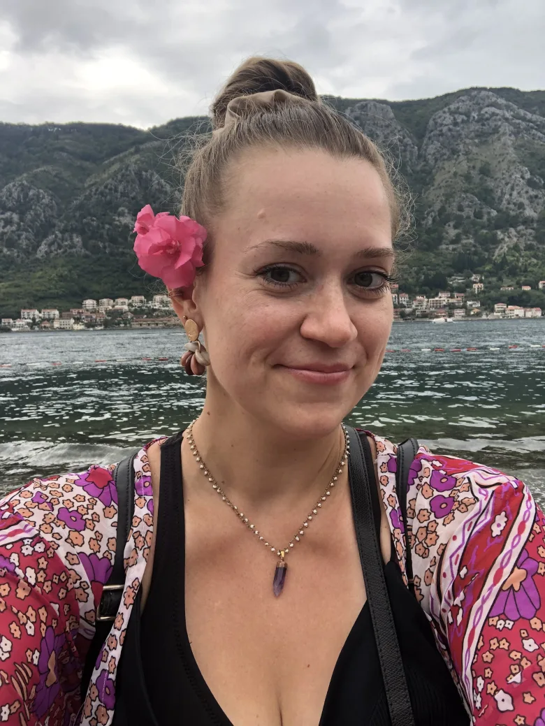 Magdalena Gajdzińska z kwiatem za uchem na tle gór